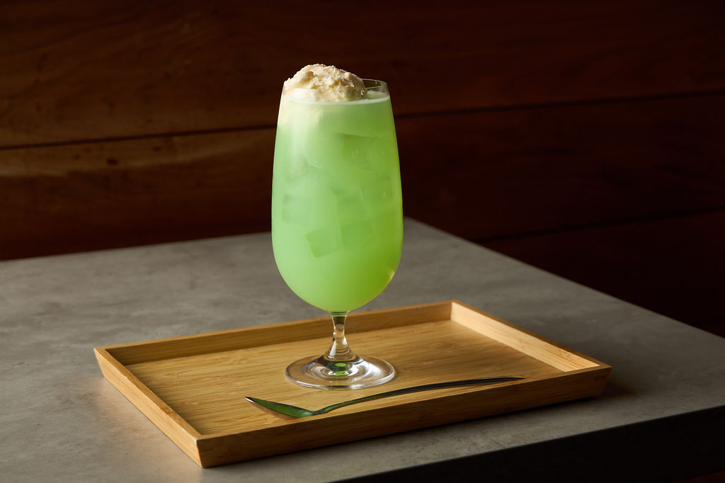 Japanese cream soda with vanilla ice cream against a warm wood-panel background